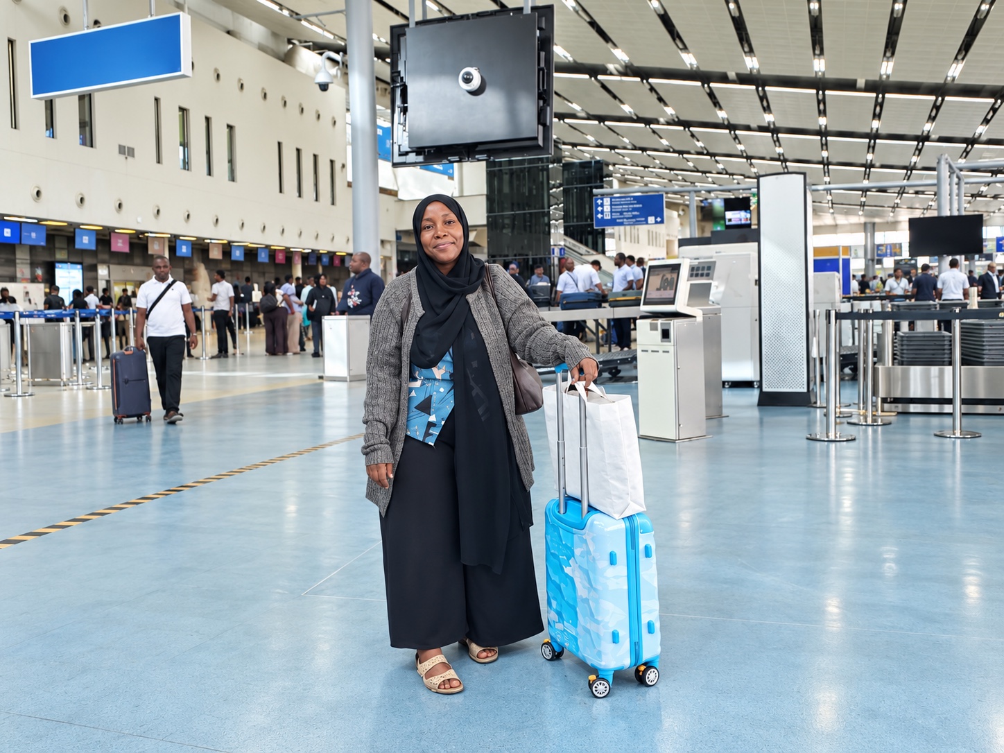 A woman with her suitcase at an airport